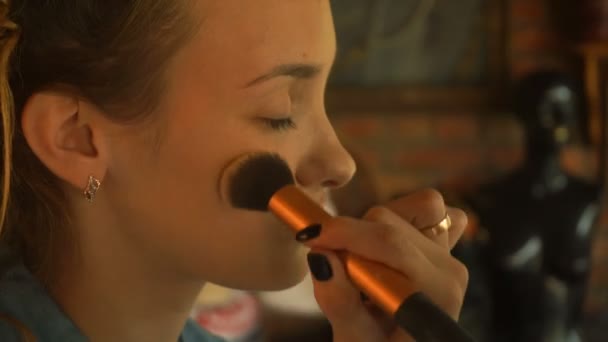 Makeup artist with brush concealer on the girls face — Stock Video