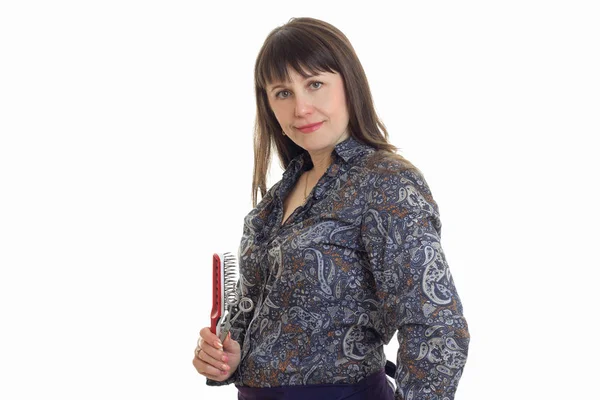 Portrait of adult woman with hairstyle tools in hands looking at the camera — Stock Photo, Image