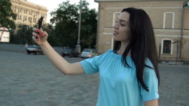 Mavi bluz çekici esmer bir fotoğraf üstünde senin telefon yapar.