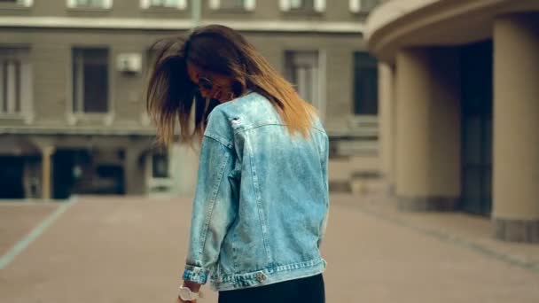 Young blonde girl with red lips smiles in the street — Stock Video