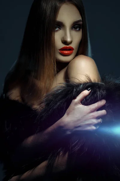 high society lady with red lips in fur coat looking at the camera