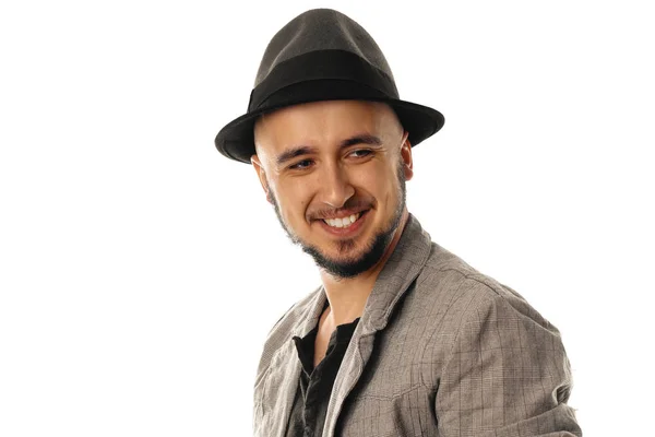 Handsome young man in hat and jacket looking away and smiling — Stock Photo, Image