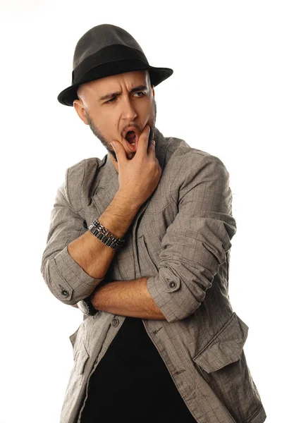 Gorgeous young man in hat and jacket looking away with open mout — Stock Photo, Image