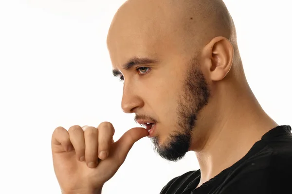 Portret van knappe macho man met vinger in zijn mond — Stockfoto