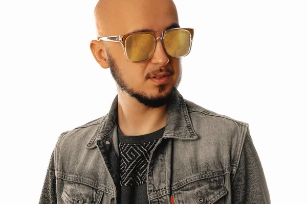 Handsome young unshaved man in sunglasses looking away — Stock Photo, Image