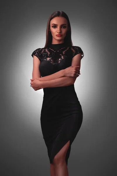 Sexy young lady in black dress in studio — Stockfoto