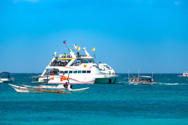 Boracay, Filipinler - 20 Ocak 2020: Gündüz vakti Boracay adasının boş beyaz plajı. Koronavirüs yüzünden Çinli turist yok. Denizdeki tekneler turist taşır..