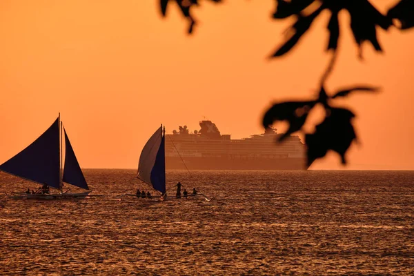 フィリピンのボラカイ島 2020年1月23日 ボラカイ島の日没 夕日を背景に海に観光客とセーリングや他の伝統的なボート 背景に有名人ミレニアムクルーズ船 — ストック写真