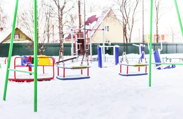 Swing on playground in winter — 图库照片