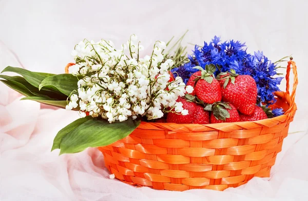 Strawberries and flowers in basket