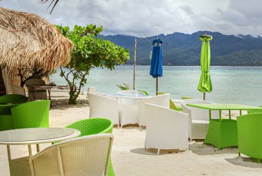 Güneşli bir günde kumsalda terk edilmiş bir kafe.