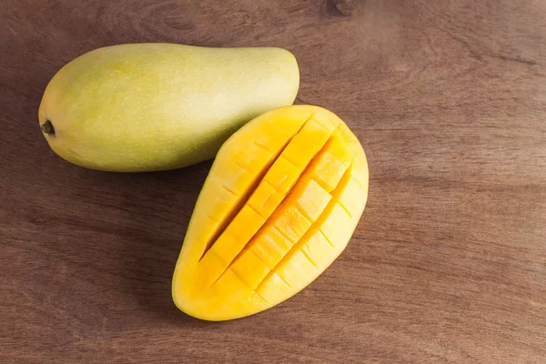 ripe mango fruit,mango slices,mango on wooden table