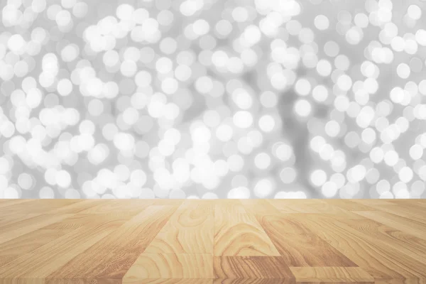 Wood table in front of white bright bokeh lights — Stock Photo, Image