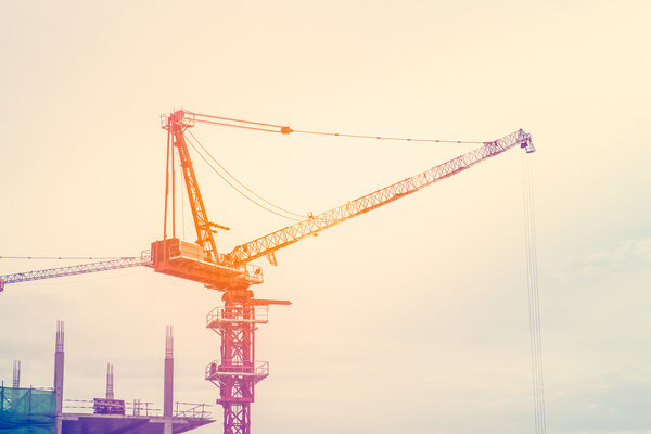 Industrial landscape with cranes on the sky background,in colorful soft style