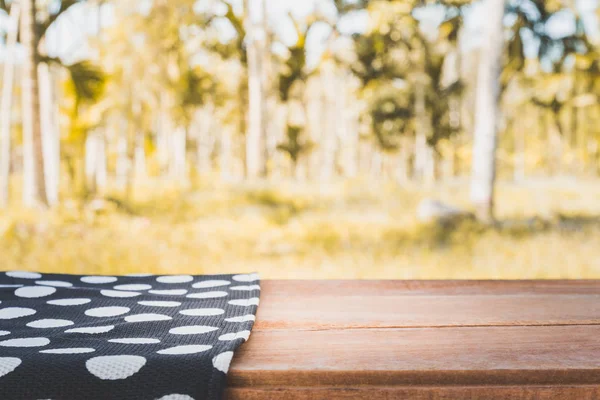 Table couverte de nappe avec fond nature, table en bois vide pour l'affichage des produits — Photo