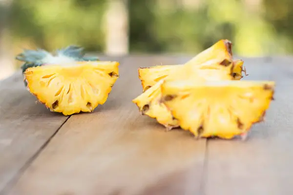 Pineapple slices on wood table , selective focus — Stock Photo, Image