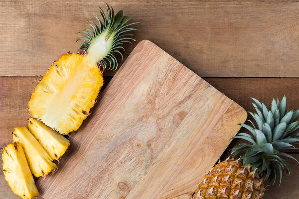 pineapple slice on wood cut board , top view