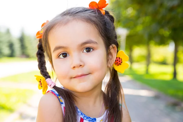 Adorable little kazakh, asian child girl on summer green nature background. — Stock Photo, Image