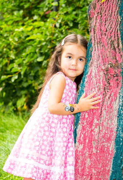 Adorable little child girl on summer green nature background. — Stock Photo, Image