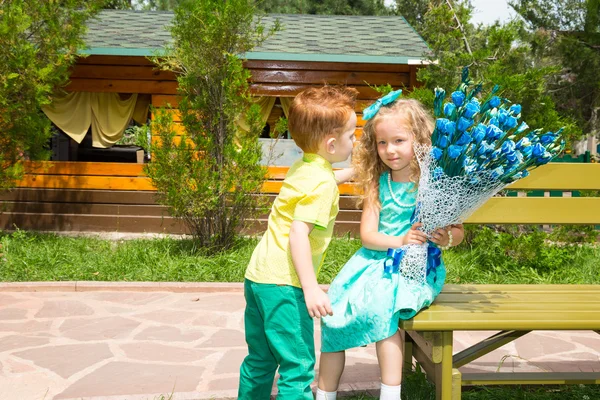 The boy gives a flower to a girl child on happy birthday. Celebration concept and childhood, love — Stock Photo, Image