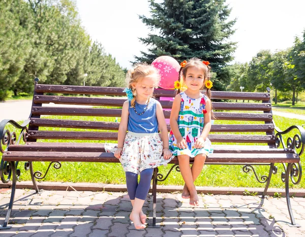 Two girlfriends. Adorable little children in park — Stock Photo, Image