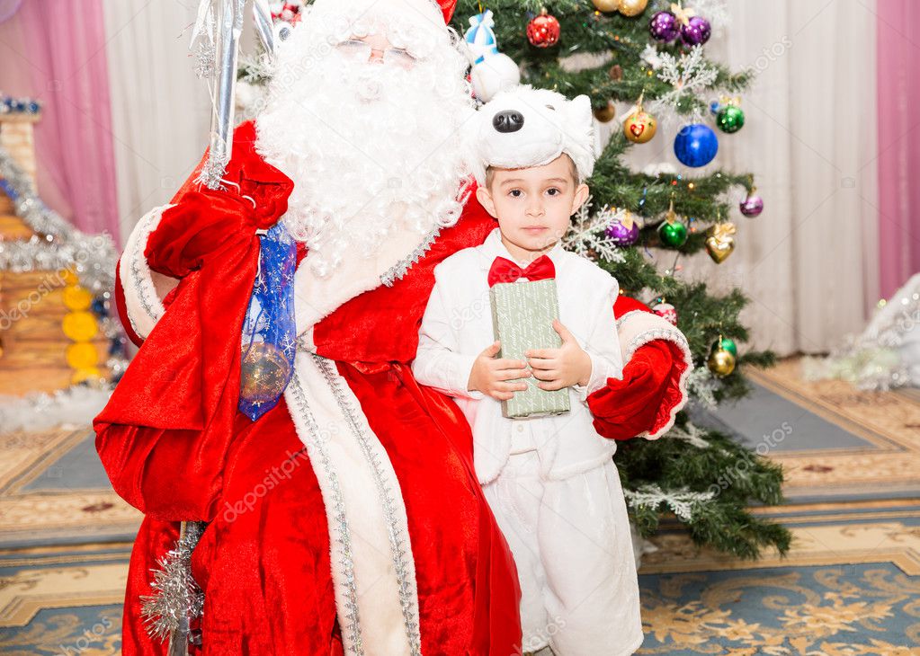 Happy little boy dressed as polar bear in New Year's holiday a children's holiday near Santa Claus