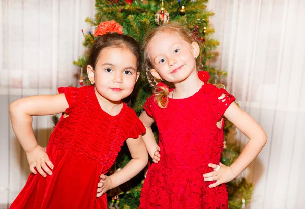 Portrait of two children girls around a Christmas tree decorated. Kid on holiday new year — Stock Photo, Image