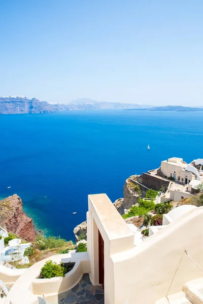 Vista da cidade de Fira - Ilha de Santorini, Creta, Grécia. Escadarias de concreto branco que levam até a bela baía com céu azul claro e mar — Fotografia de Stock