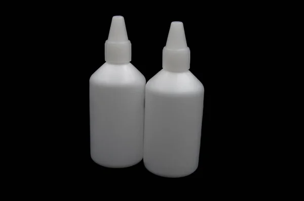 White medicine bottle on black background — Stock Photo, Image