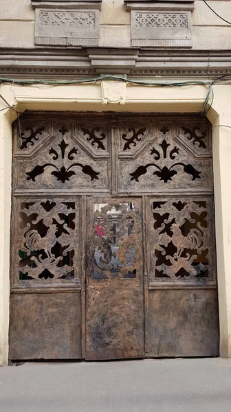 Old weathered metallic gates of house