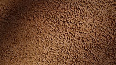Sert alçı sıva duvar dokusu yakın çekim. Kopya alanı olan soyut desenli kahverengi arkaplan