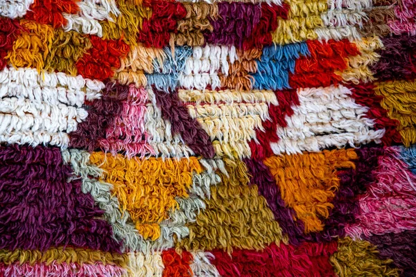 Colorful fluffy carpet with rhombus pattern. Turkish ornamental carpet background. Woven texture. Ethnic pattern rug. Traditional Asian ornaments. Turkish bazaar backdrop