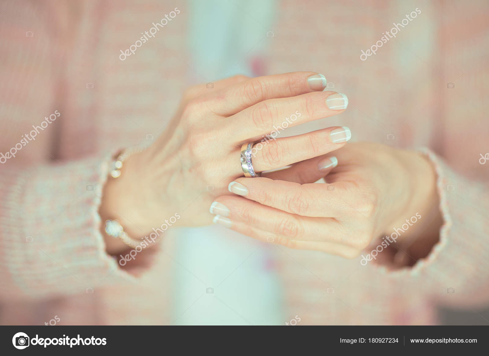 Married Woman Hands Touching Her Wedding Ring Closeup Light Pink
