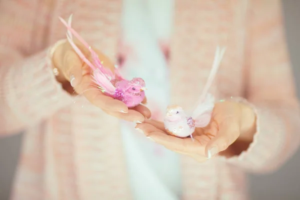 Woman Hands Holding Little Artificial Bird Her Hands Light Pink — Stock Photo, Image