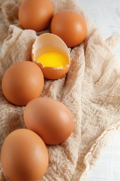 kahverengi tavuk yumurta bir yumurta sarısı görünür peçete, Beyaz ahşap rustik gıda fotoğraf üzerinde dekore edilmiş arka plan olarak kullanılabilir