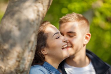 Eğleniyor, konuşurken, güneşli parkta ilkbaharda, güzel, romantik ruh hali flört genç Çift