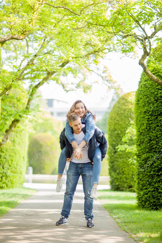 Young couple having fun in a sunny park in springtime, beautiful, romantic mood