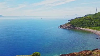 Engebeli kıyı şeridi ve sınırsız Azure okyanus mavi gökyüzü karşı