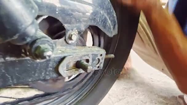 Manos montan cadena de rueda de scooter — Vídeo de stock