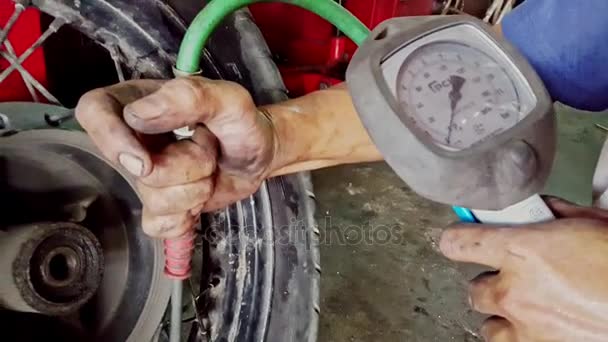 Man Controls Pressure in Tire with Manometer in Shop — Stock Video