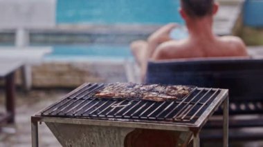 Barbekü ateşe et parçası pişirir 