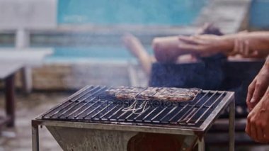 Barbekü ateşe et parçası pişirir 