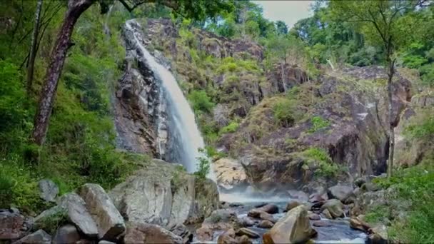 Lake among rocky banks with mountain waterfall — Stock Video