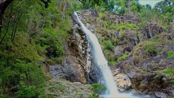 Lake among rocky banks with mountain waterfall — Stock Video