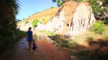 Anne ve kızı çıplak ayakla peri akışta yürüyüş