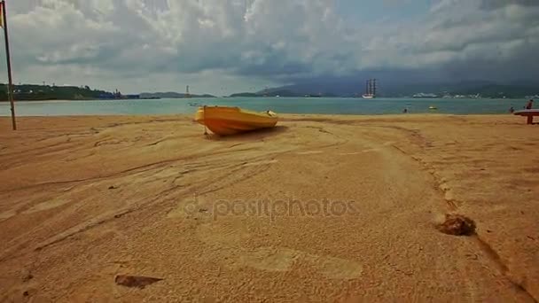 Träbåt på sandstrand mot havet — Stockvideo
