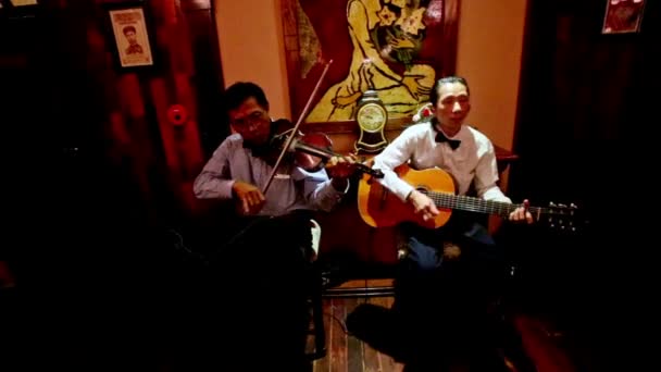 Ресторан с местным гитаристом, скрипачом играет музыку — стоковое видео