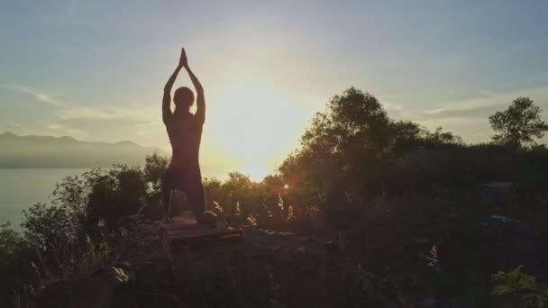 Girl doing yoga on large cliff — Stock Video