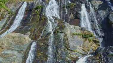 şelale sarp kayalık yamaçlar arasında