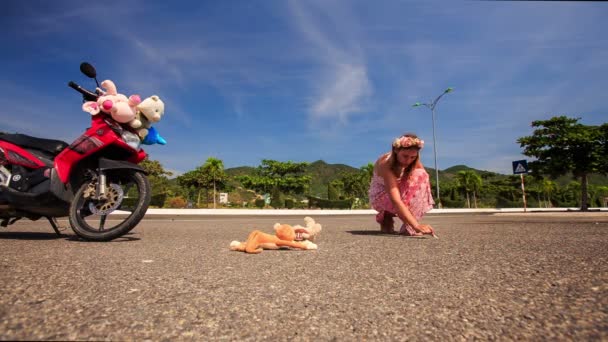 Vrouw trekt foto op asfalt door motorfiets — Stockvideo